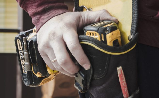 man with PAT testing equipment in pocket