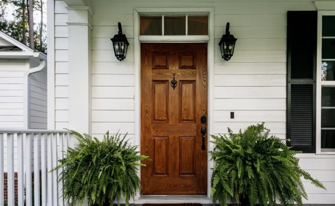 Brown,Wood,Front,Door,Of,A,White,Siding,Southern,House