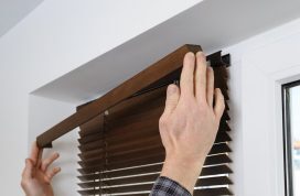 Installing,Wooden,Blinds.,A,Man,Attaches,A,Decorative,Bar,On