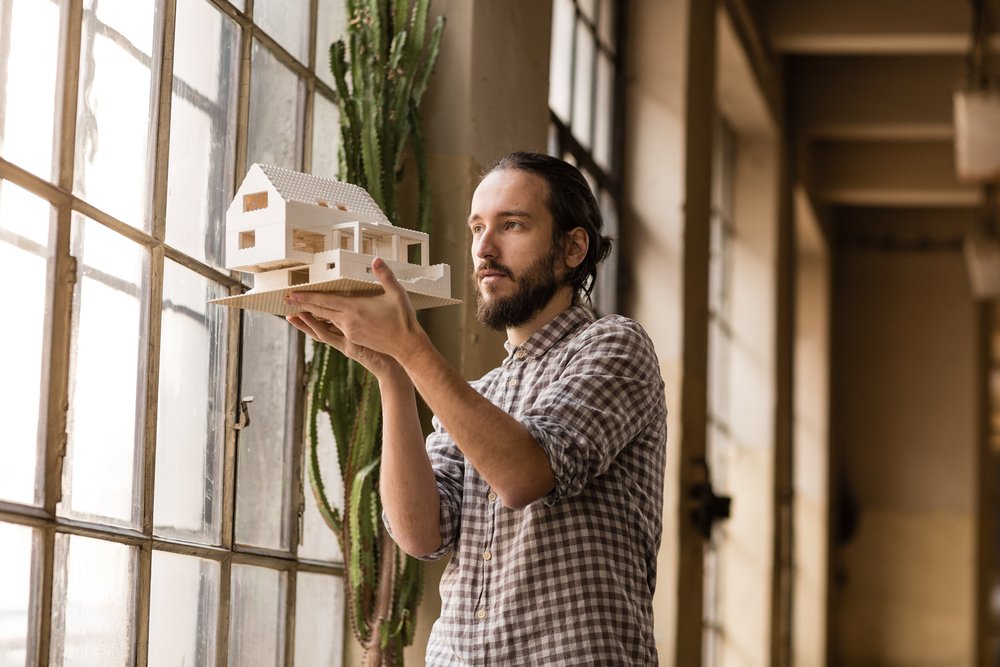 Architect looking at model of building