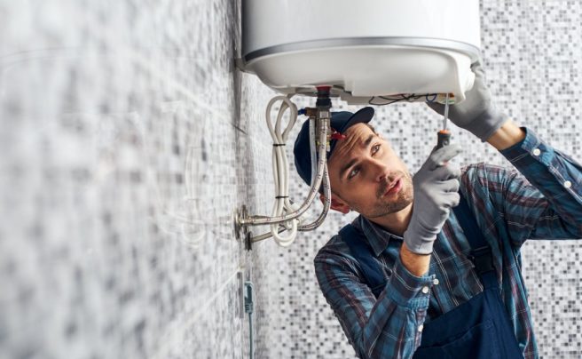 Almost,Done.,Worker,Set,Up,Electric,Heating,Boiler,At,Home.