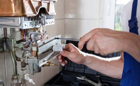 Repairman,Fixing,A,Gas,Water,Heater,With,A,Screwdriver