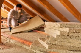 Man,Installing,Thermal,Insulation,Layer,Under,The,Roof,-,Using